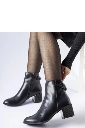 Black ankle boots decorated with a chain