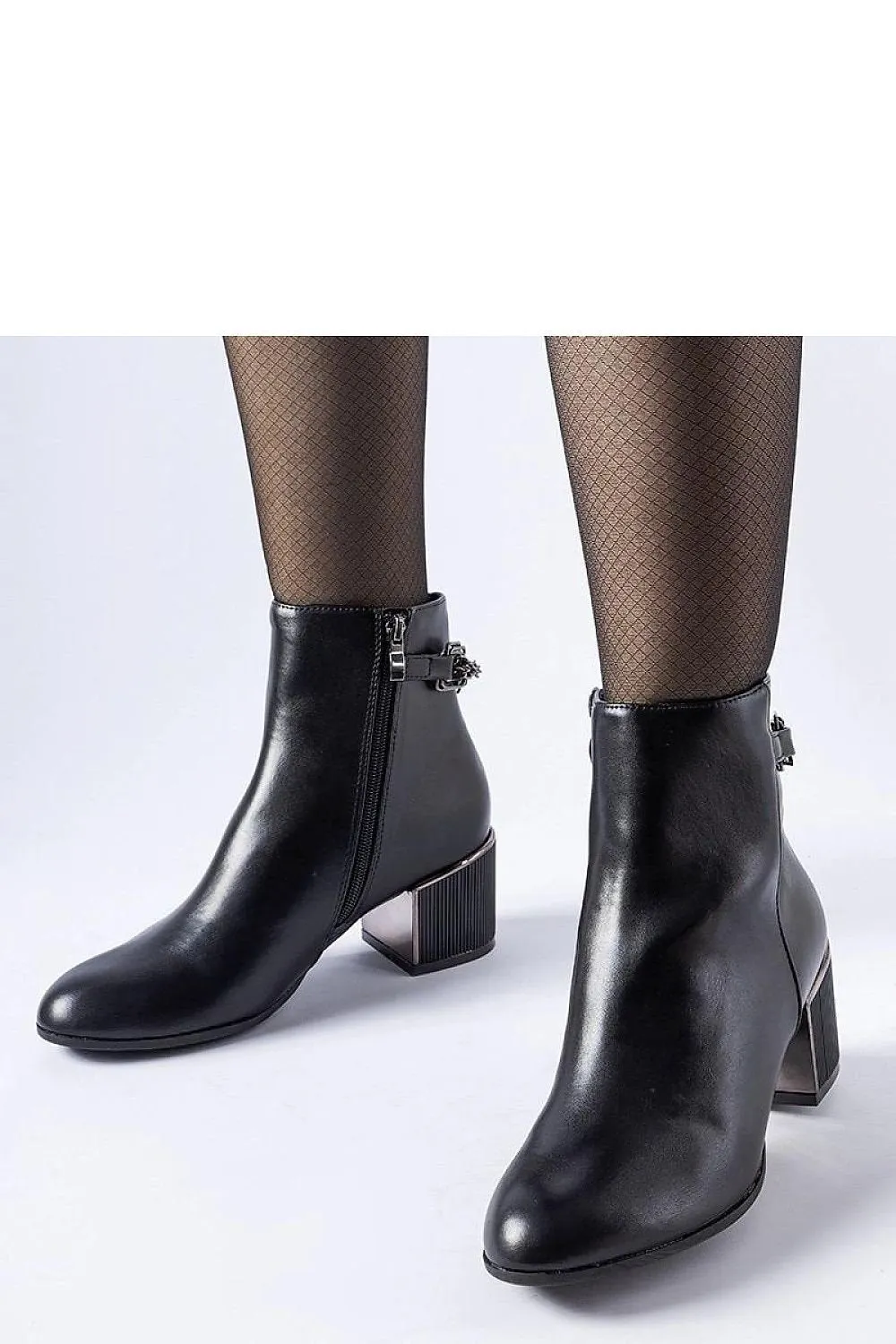 Black ankle boots decorated with a chain